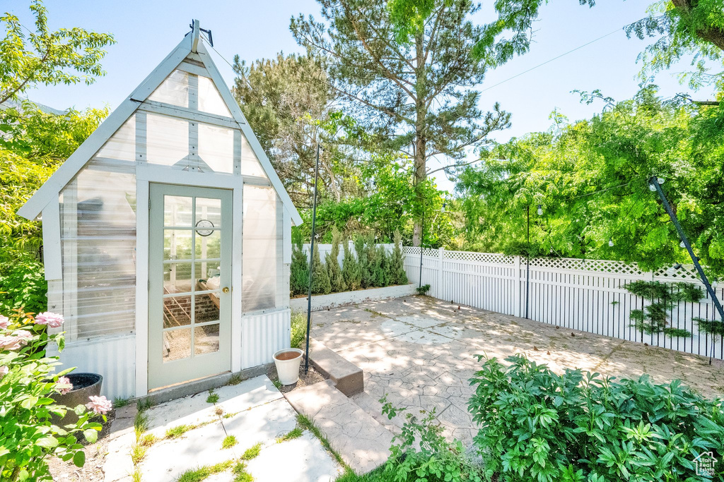 View of greenhouse with a fenced backyard