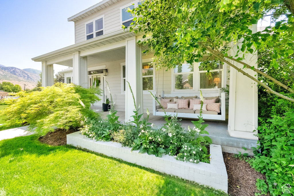 View of front facade featuring a porch, a mountain view, and an outdoor living space