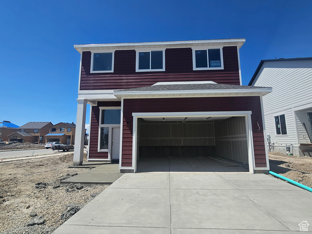 View of front of property featuring driveway and a garage