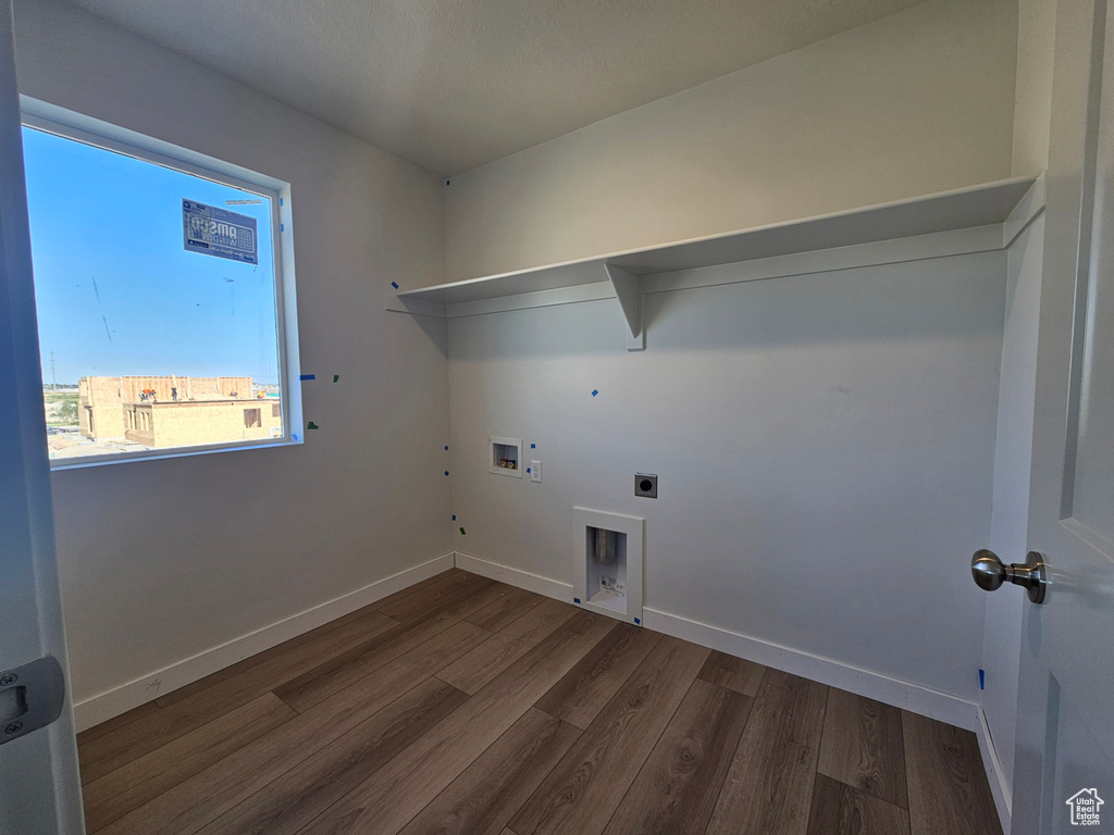 Laundry room with hookup for an electric dryer, dark wood finished floors, hookup for a gas dryer, and washer hookup