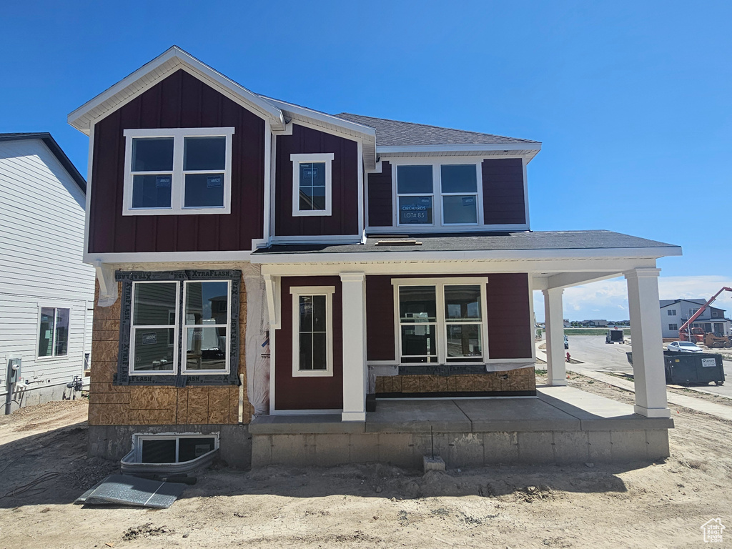 View of front of property with a porch and board and batten siding