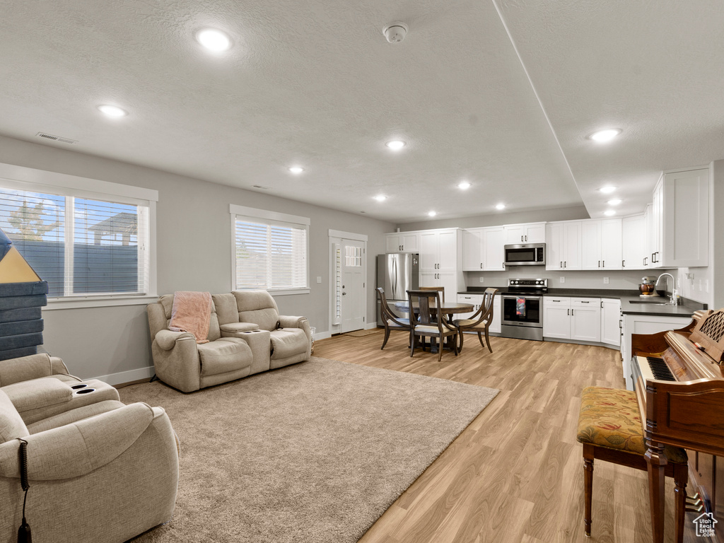 Living room featuring recessed lighting and light wood finished floors