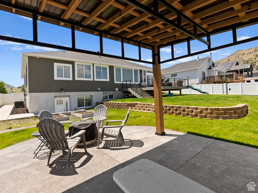 View of patio / terrace featuring an outdoor fire pit, a playground, a residential view, stairway, and a wooden deck