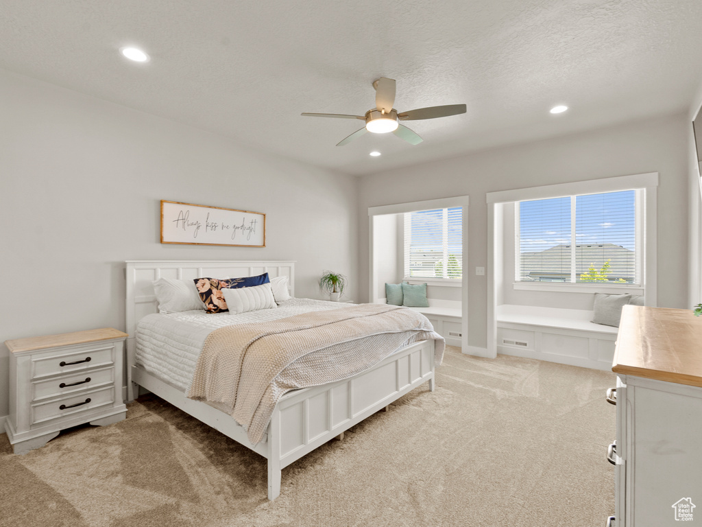 Bedroom with light carpet, recessed lighting, and a ceiling fan