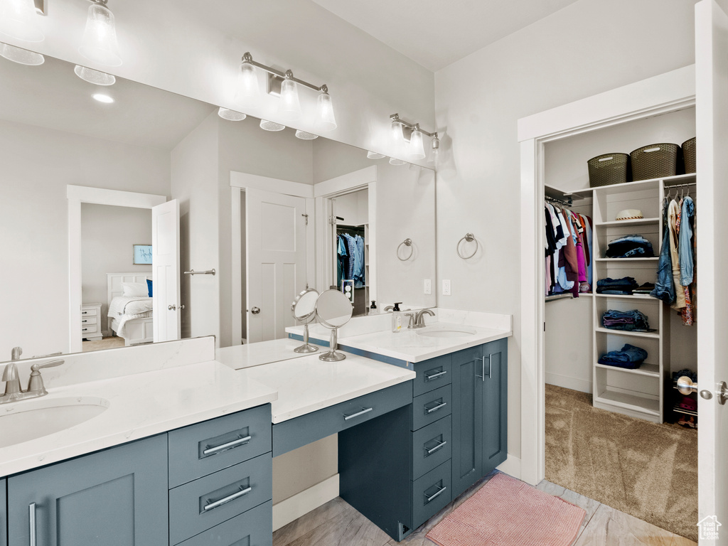 Ensuite bathroom with two vanities and a spacious closet