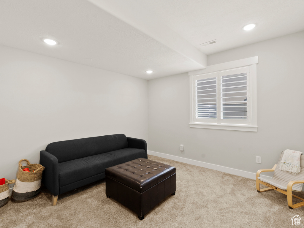 Living area featuring light colored carpet and recessed lighting