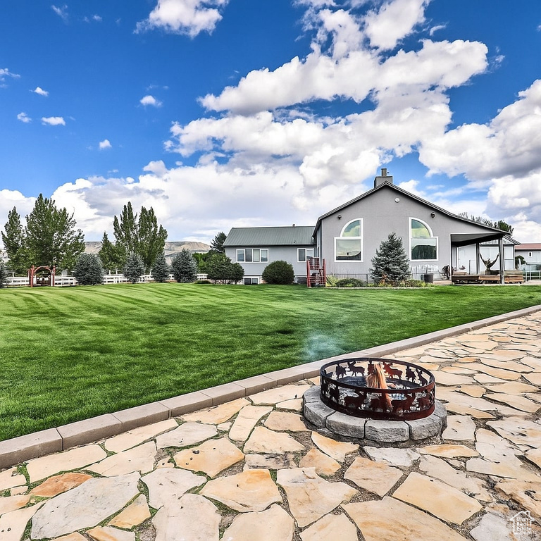 View of patio featuring an outdoor fire pit