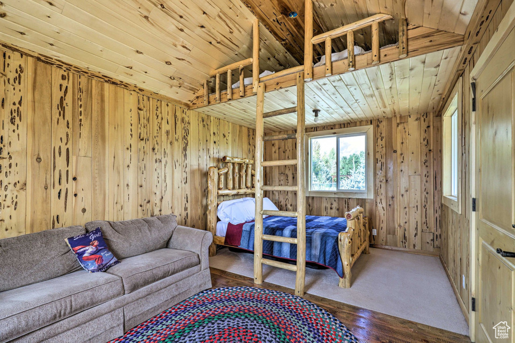 Bedroom with wooden walls and wood finished floors