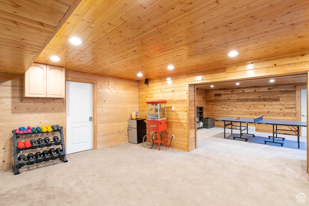 Rec room with carpet floors, wood walls, wooden ceiling, and recessed lighting
