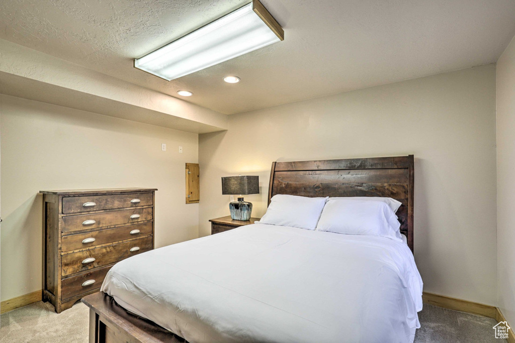 Carpeted bedroom featuring baseboards and recessed lighting