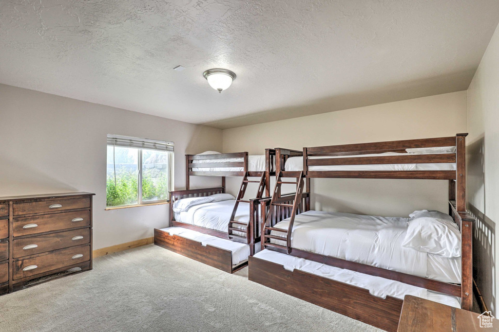 Bedroom with carpet flooring and a textured ceiling