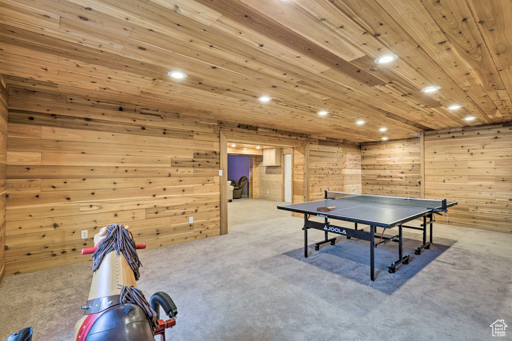 Game room with carpet flooring, wooden walls, recessed lighting, and wooden ceiling
