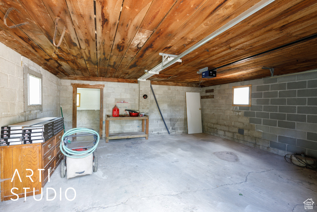 Below grade area featuring a garage and concrete block wall