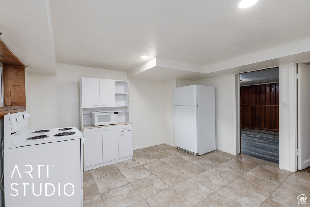 Kitchen with white appliances, open shelves, white cabinetry, recessed lighting, and light countertops