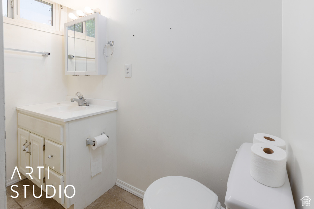 Half bathroom featuring vanity and tile patterned floors