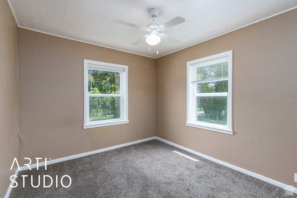 Unfurnished room featuring carpet floors and ceiling fan