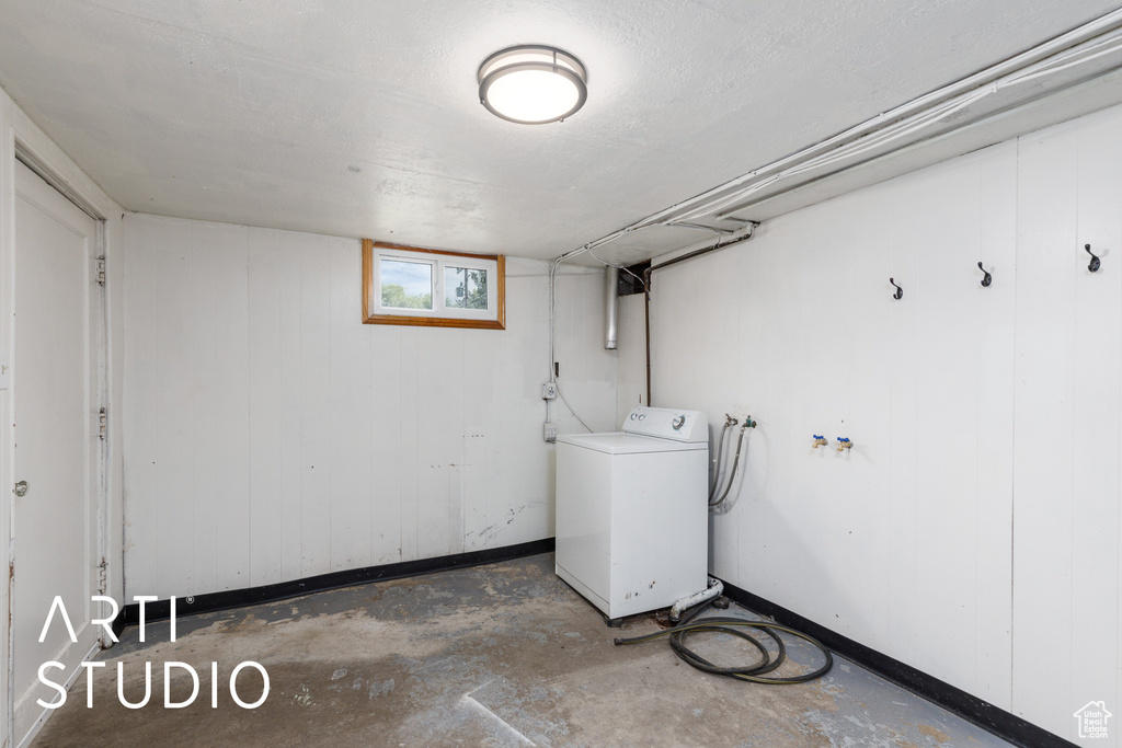 Basement featuring washer / clothes dryer and baseboards