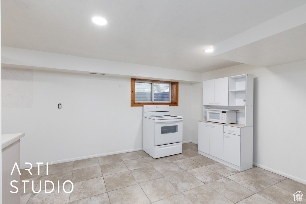 Kitchen featuring white appliances, open shelves, white cabinets, light countertops, and recessed lighting