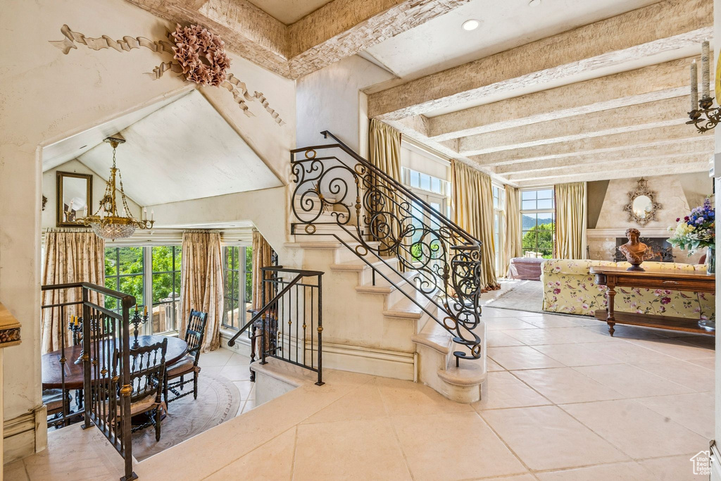 Stairs featuring tile patterned floors and beam ceiling