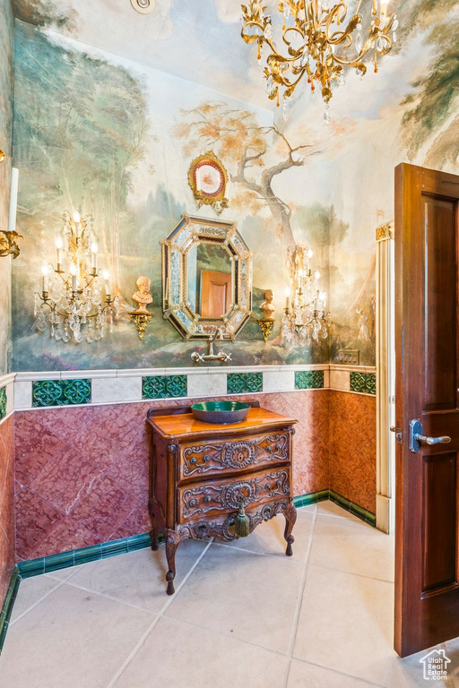 Bathroom with a chandelier, tile patterned flooring, and vanity