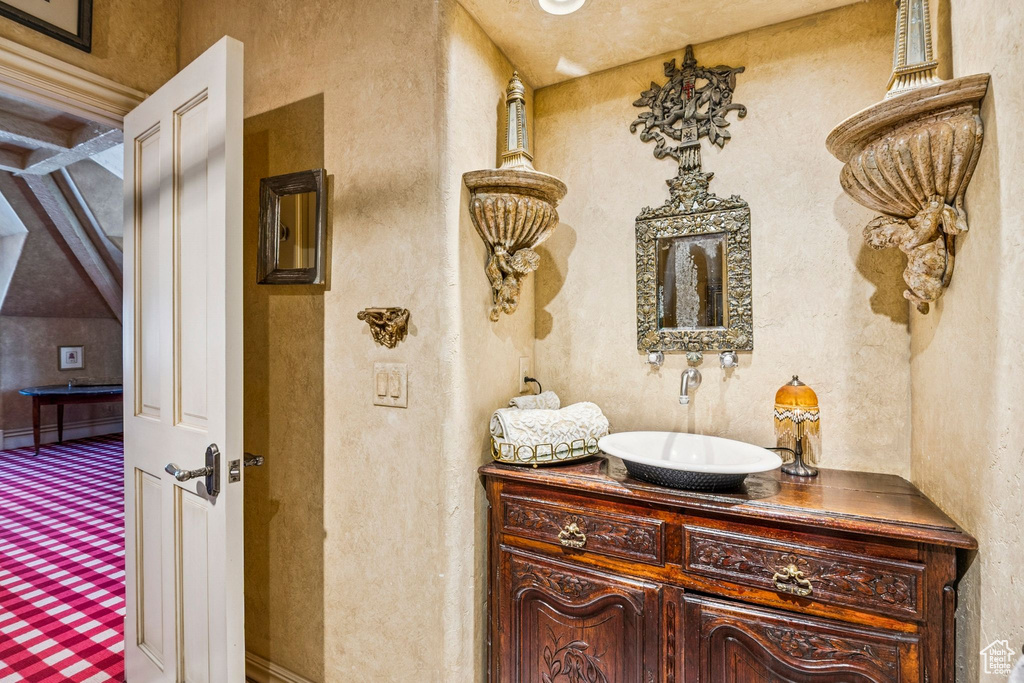 Bathroom featuring vanity and a textured wall