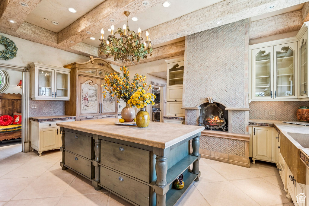 Kitchen with cream cabinetry, light tile patterned flooring, tasteful backsplash, open shelves, and recessed lighting