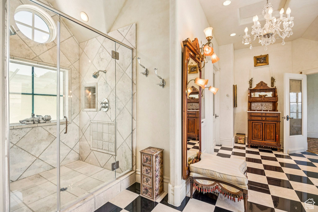 Bathroom with a shower stall, a chandelier, vaulted ceiling, recessed lighting, and french doors