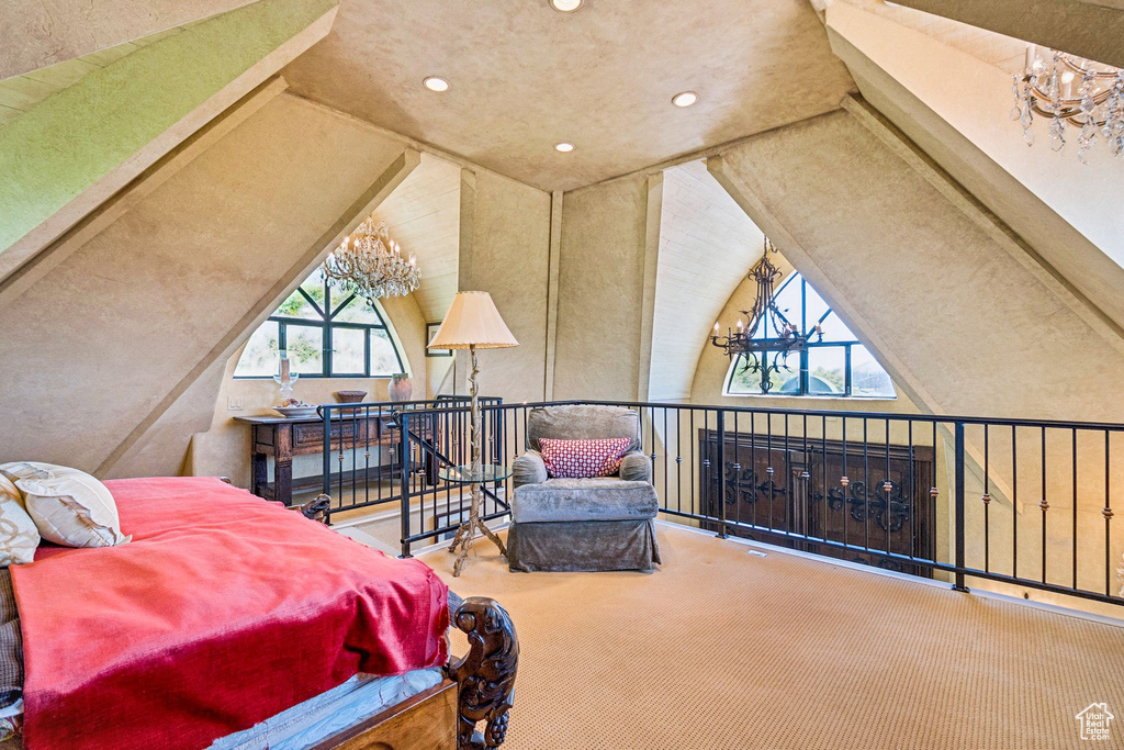 Carpeted bedroom with lofted ceiling, recessed lighting, and a chandelier