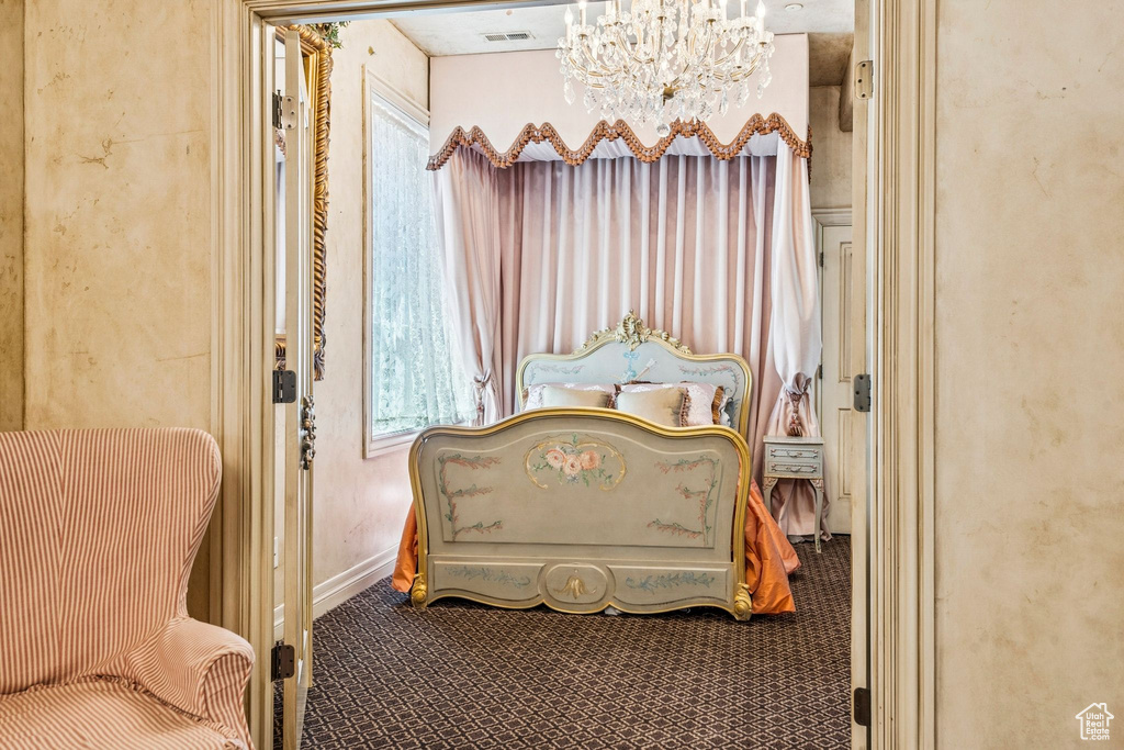 Bedroom with a chandelier and carpet