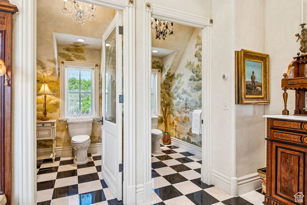 Bathroom featuring tile patterned floors, vanity, and a chandelier