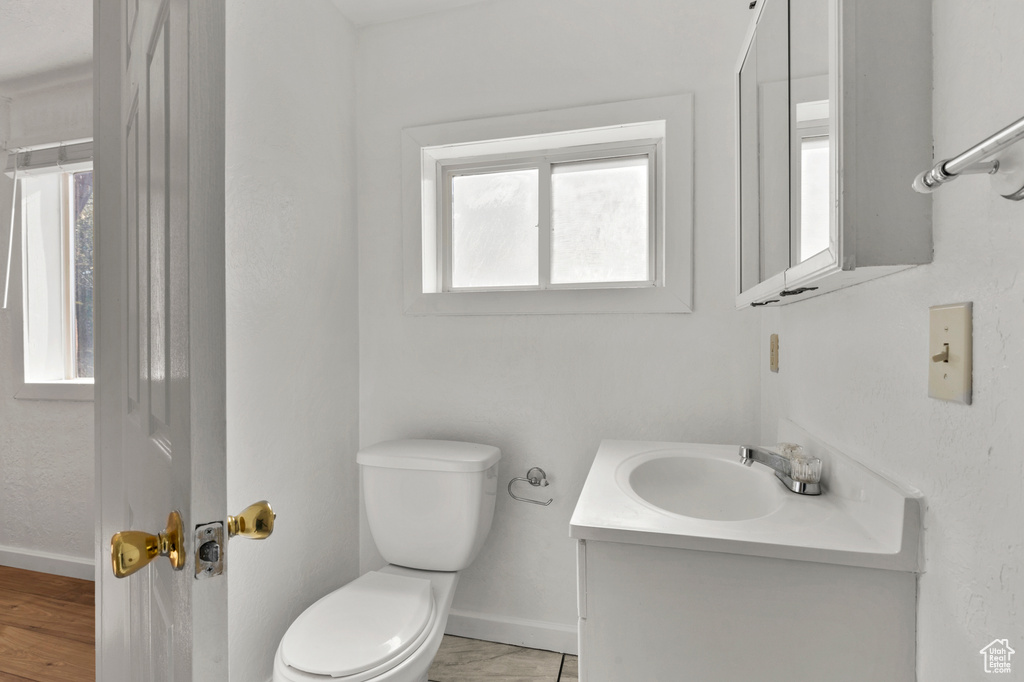 Half bathroom featuring plenty of natural light and vanity