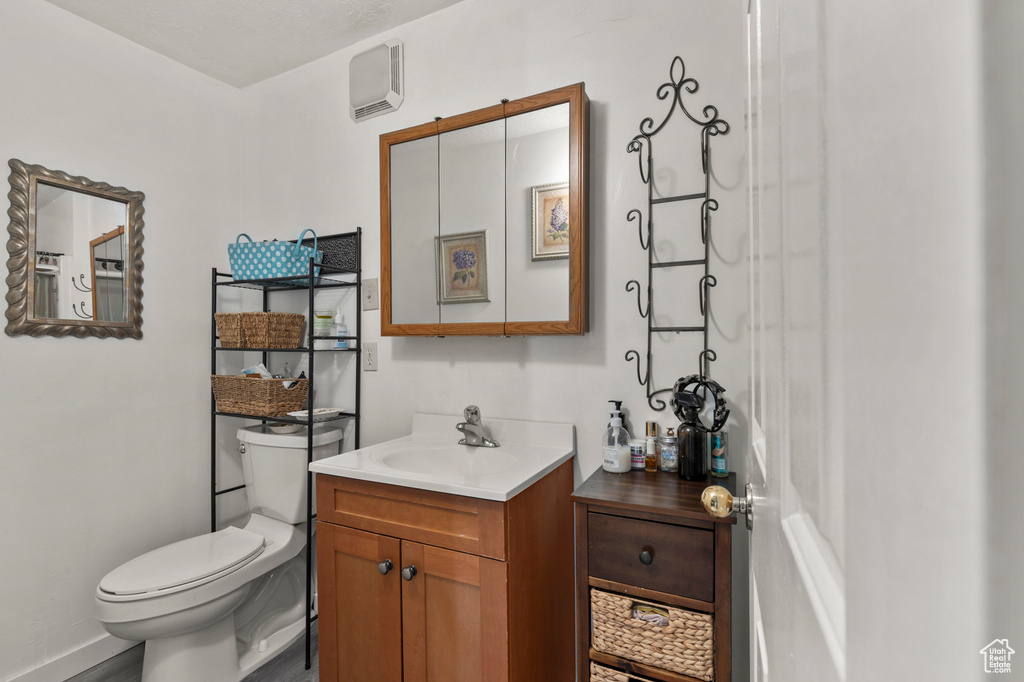 Half bathroom with toilet and vanity