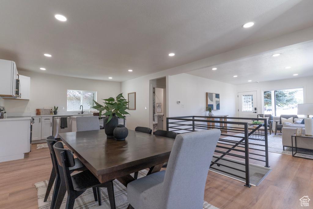 Dining space with plenty of natural light, recessed lighting, and light wood-type flooring