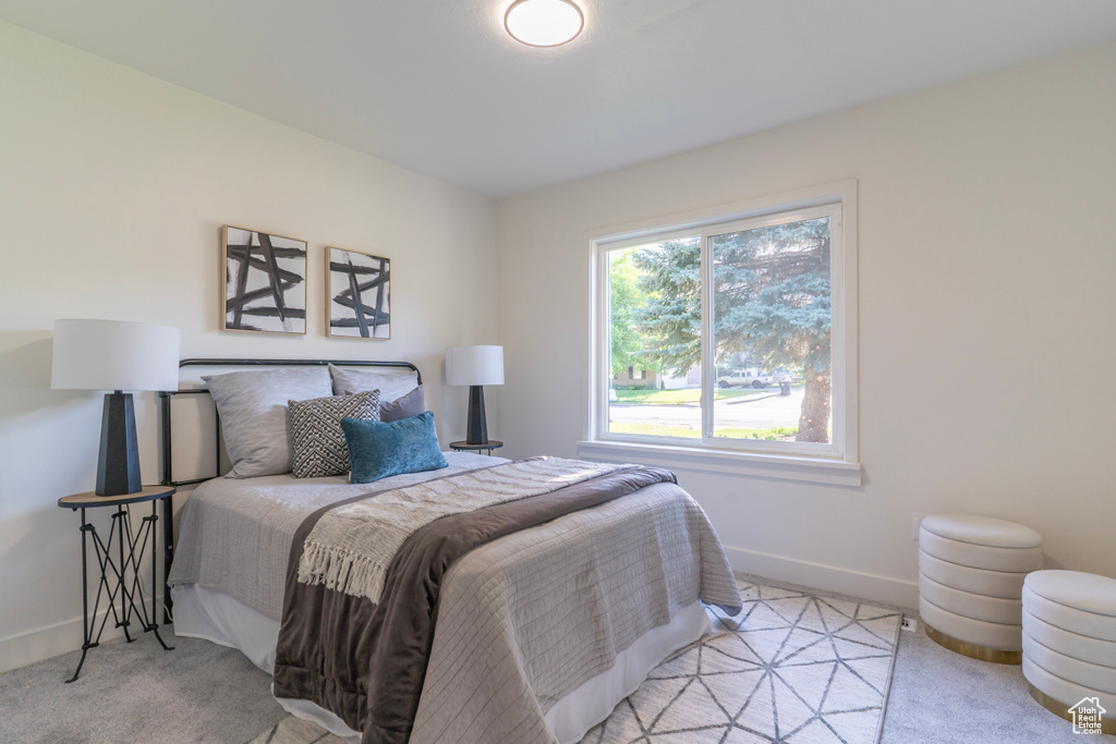 Bedroom with light carpet and baseboards