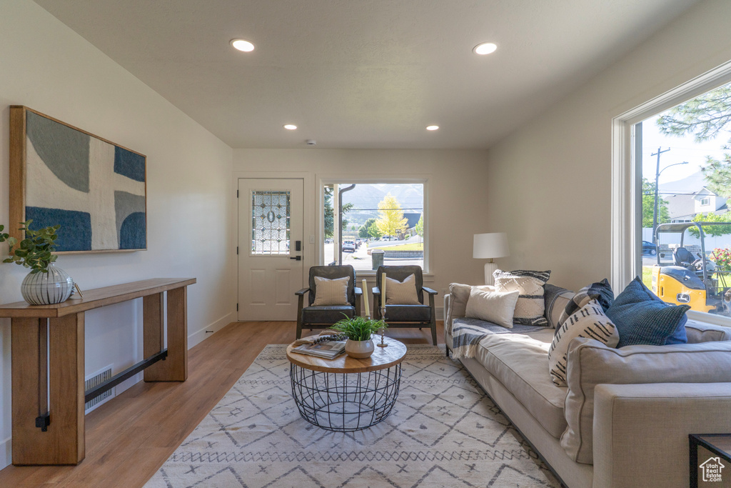 Living area with recessed lighting and light wood-style floors