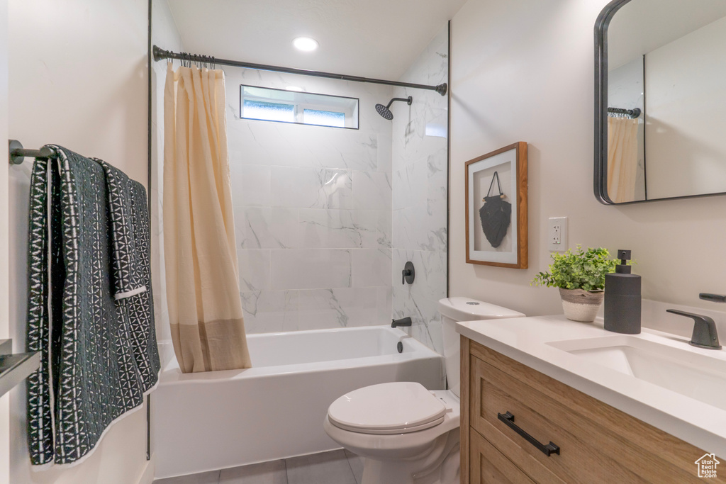 Full bathroom with shower / bathtub combination with curtain, vanity, and tile patterned flooring