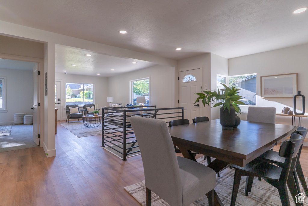 Dining area with light wood-style flooring and recessed lighting