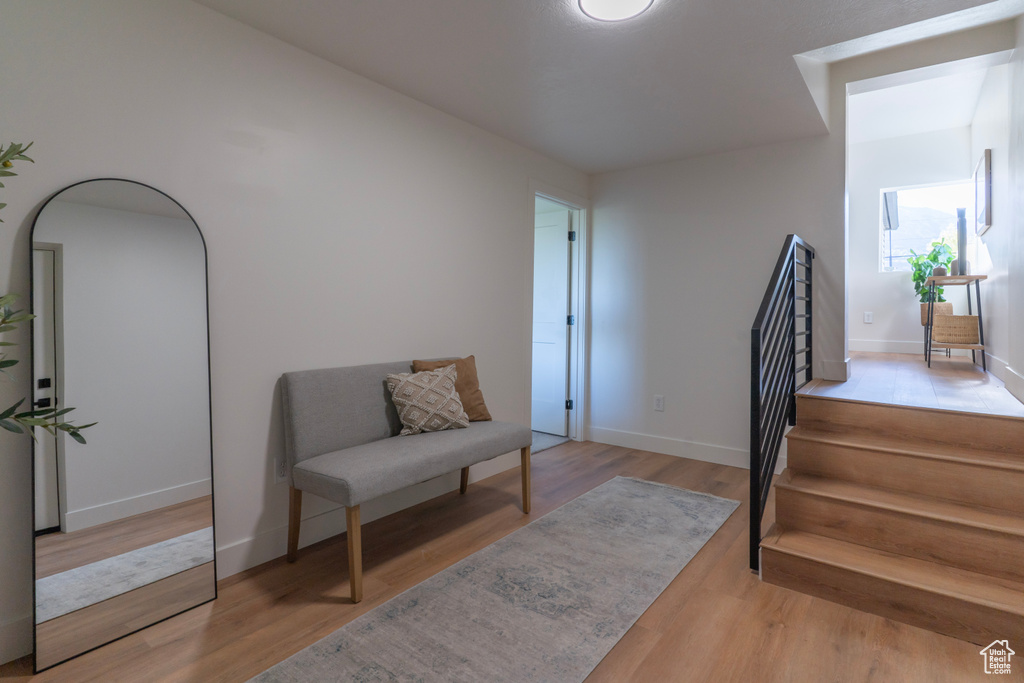 Sitting room with wood finished floors and stairs