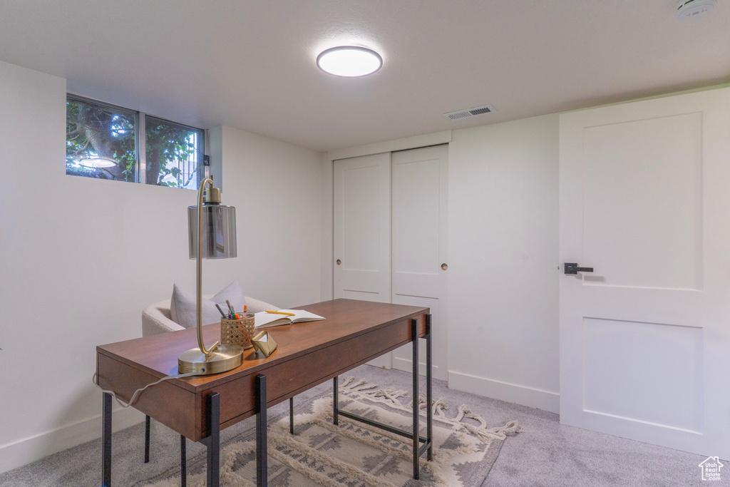 Home office featuring baseboards and light carpet