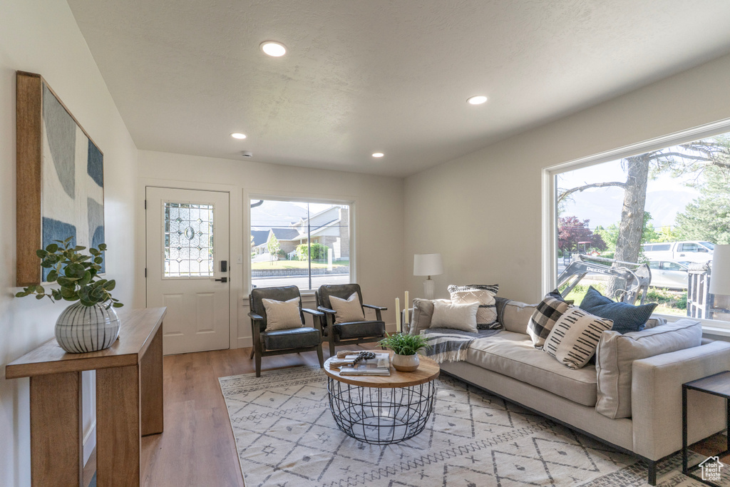 Living room with recessed lighting, light wood-type flooring, and plenty of natural light