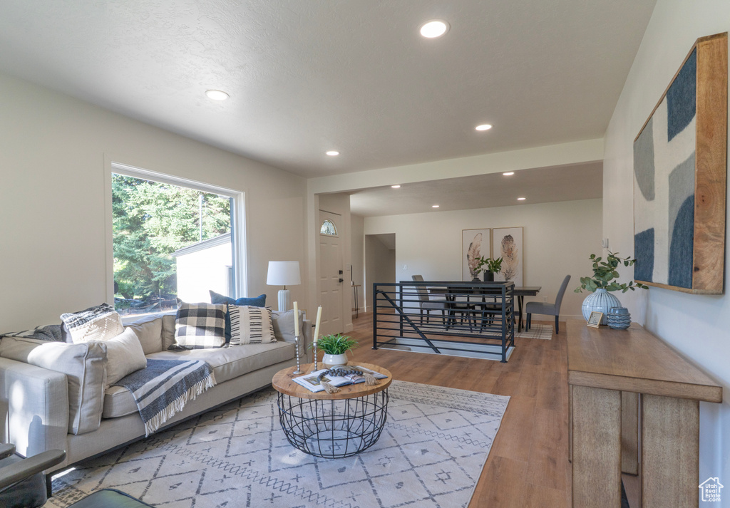 Living room with recessed lighting and wood finished floors