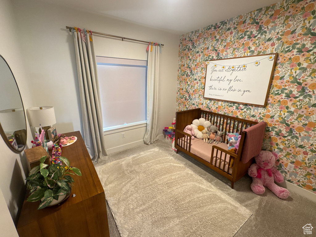 Carpeted bedroom featuring wallpapered walls and baseboards