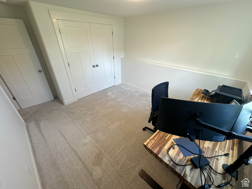 Office with light carpet and baseboards