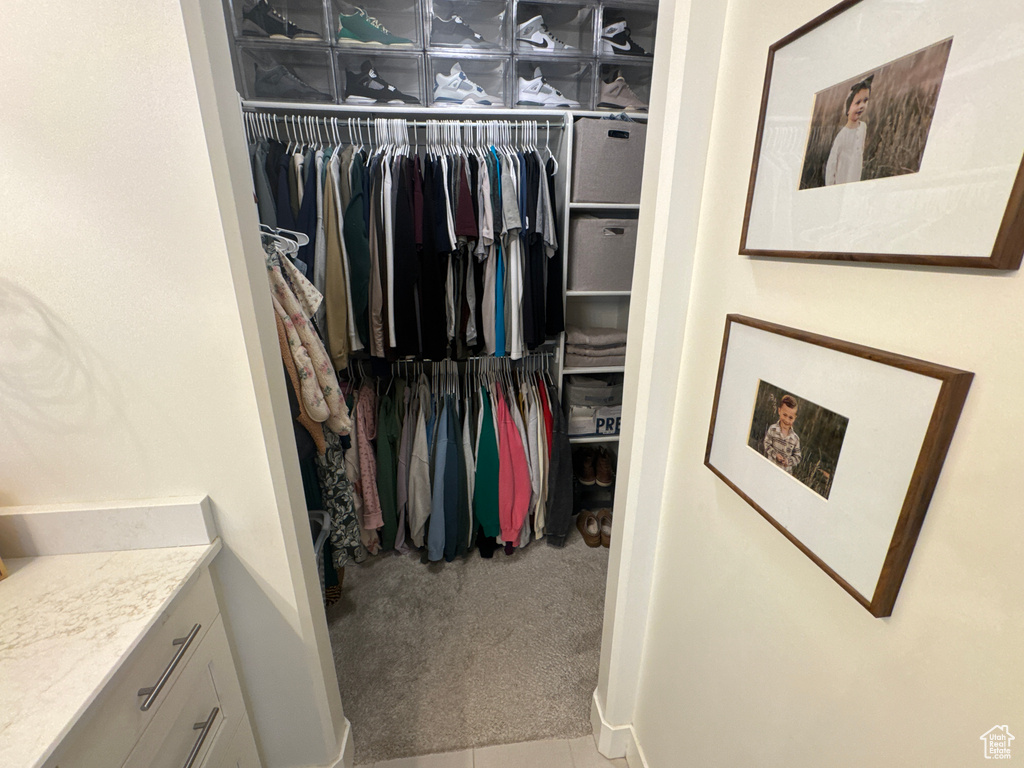 Spacious closet with carpet flooring and tile patterned flooring