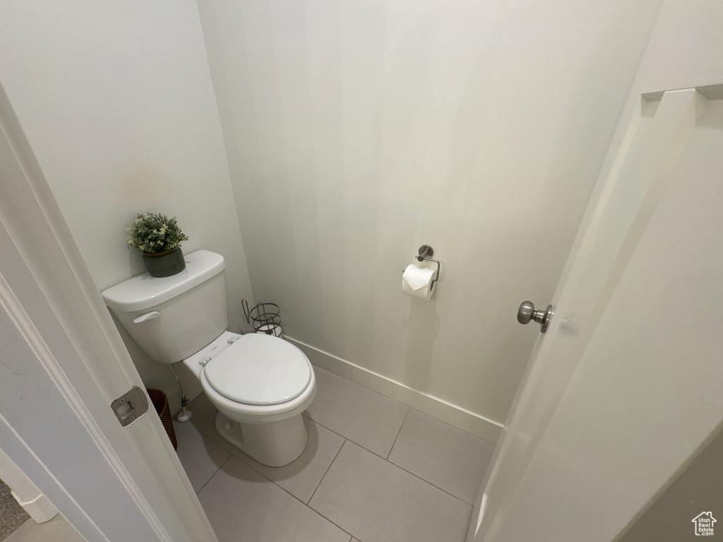 Bathroom featuring toilet and tile patterned flooring