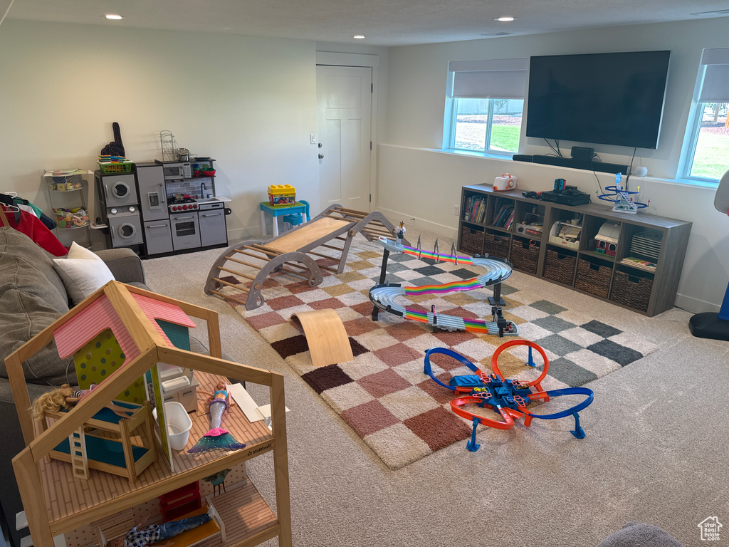 Carpeted living area with recessed lighting