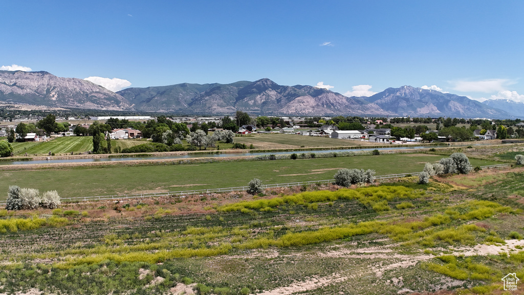 View of mountain background featuring a large body of water and rural landscape