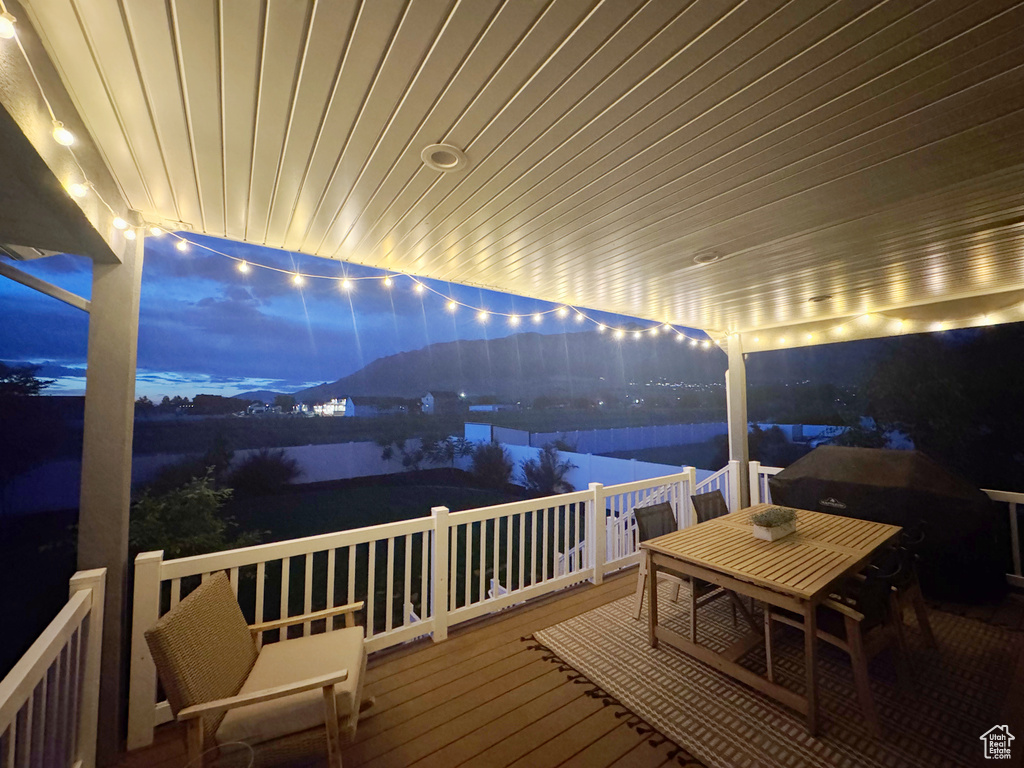 Deck at twilight featuring outdoor dining area