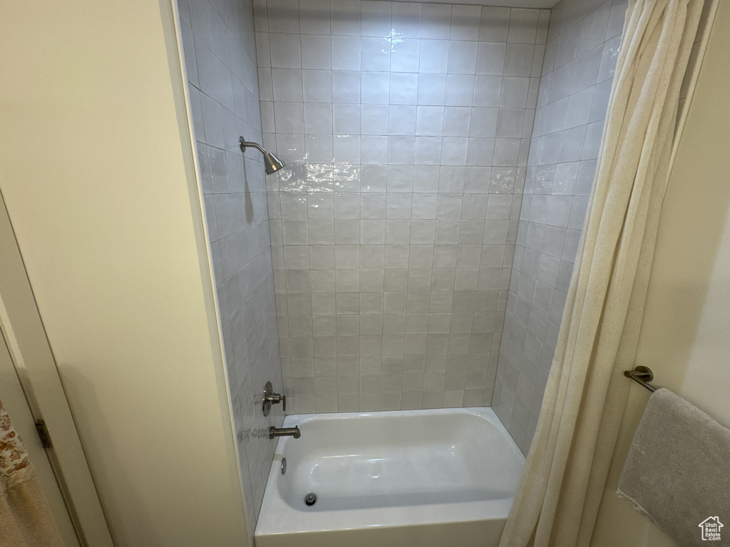 Full bathroom with shower / bath combination with curtain