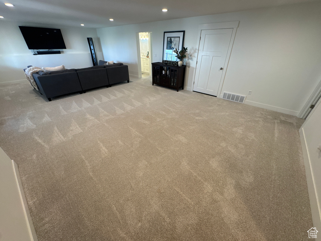 Living room featuring recessed lighting and light carpet